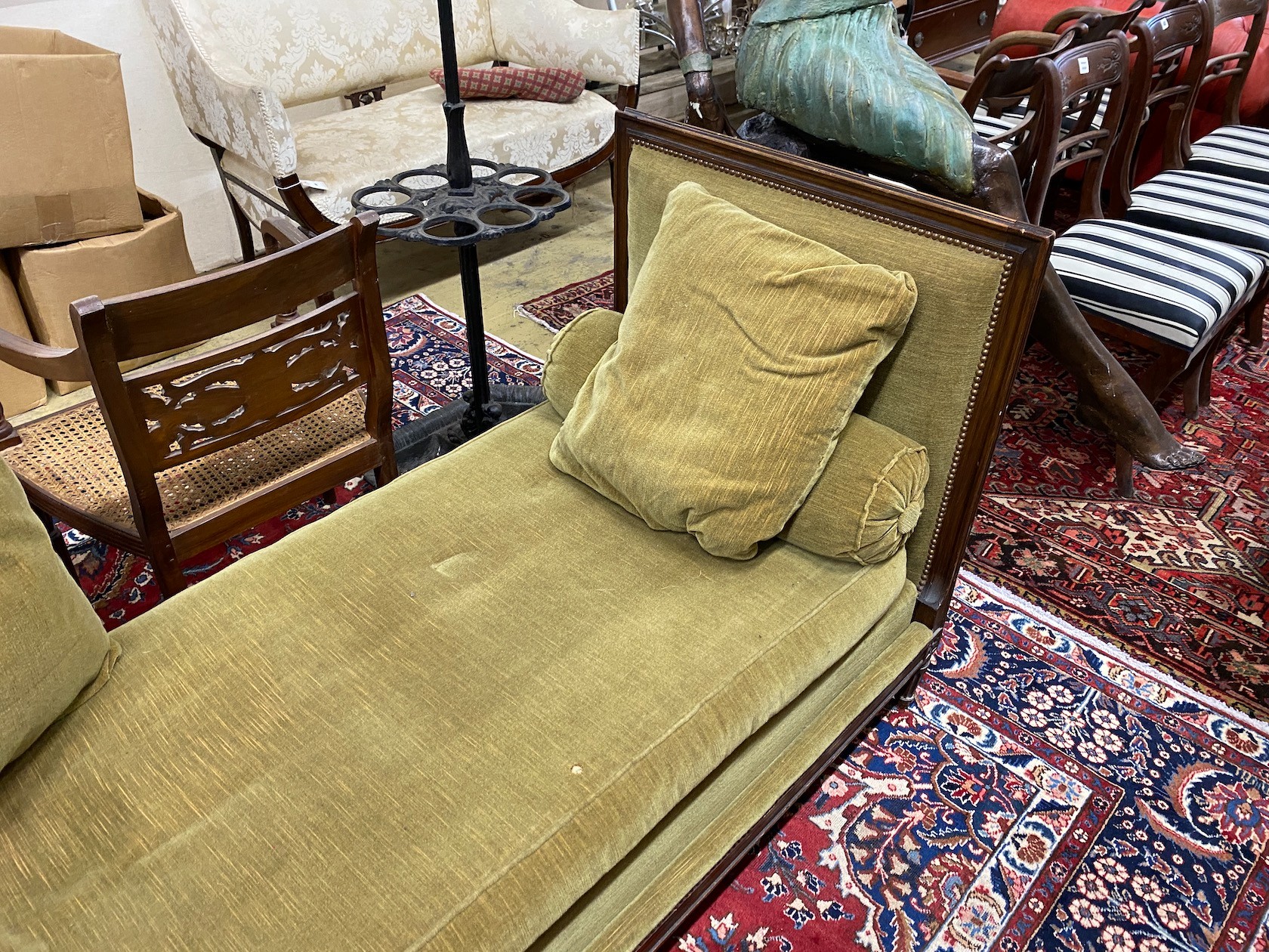 An early 20th century French upholstered mahogany day bed, length 184cm, depth 76cm, height 90cm